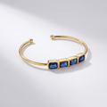 RB Jewelry Linear Cuff - gold open cuff bracelet with row of blue stones